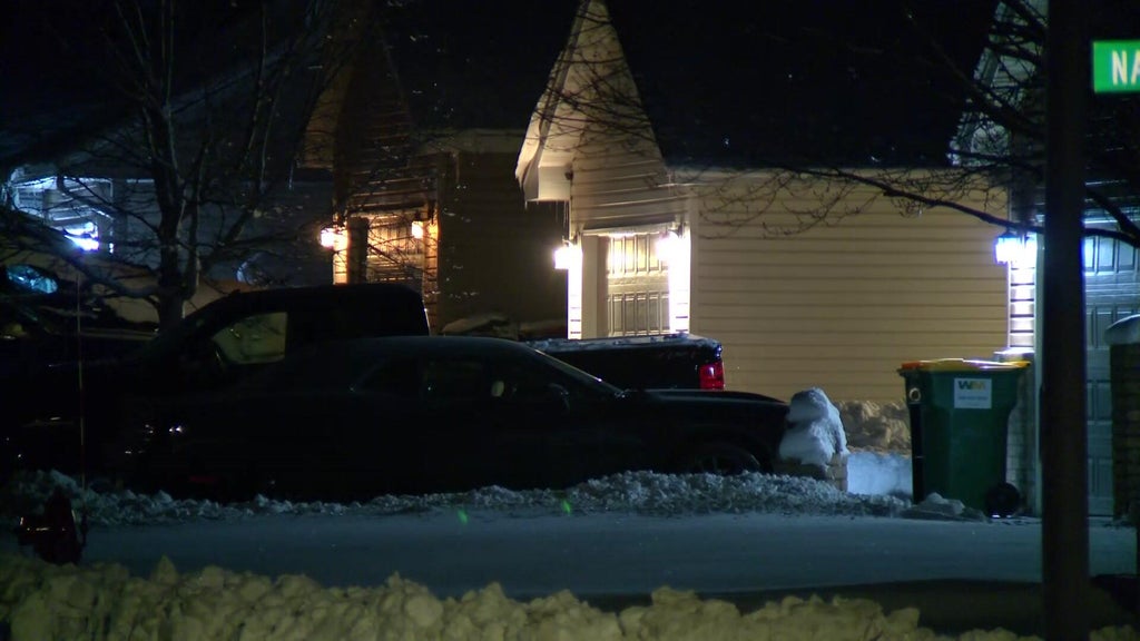 Police lights flashing outside a suburban home at night, symbolizing a welfare check gone wrong.